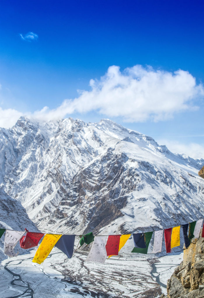 Buddhist prayer flag fluttering over Dhankar Monastery