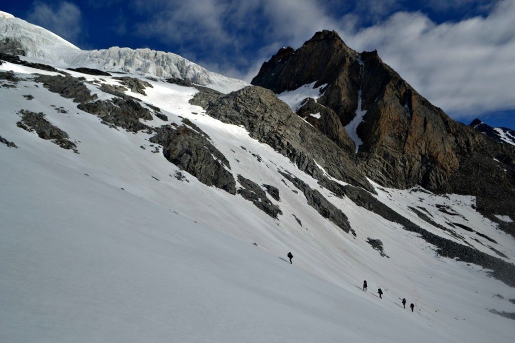 Climbing over a glacier to the basecamp of Lamkhaga