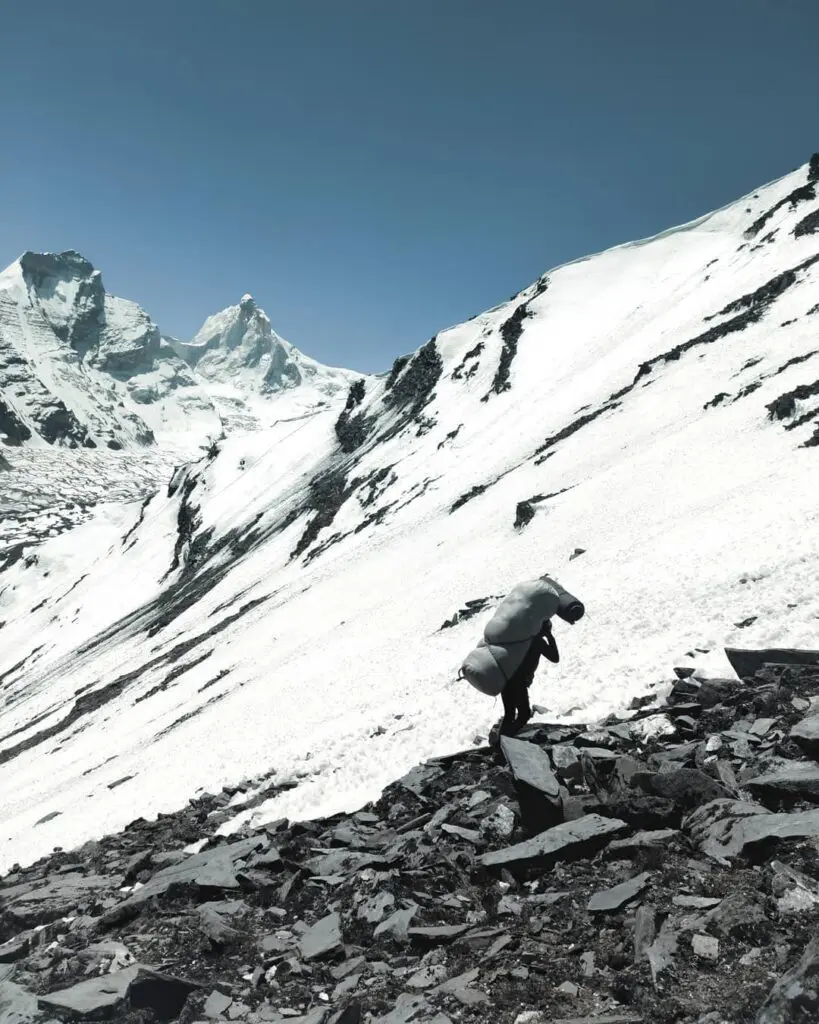 Porters, Superheroes of Himalayas. a porter carrying load up to the basecamp of Patangini Dhar