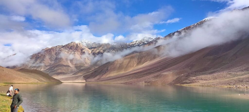 People walking by the shore of Chandratal lake