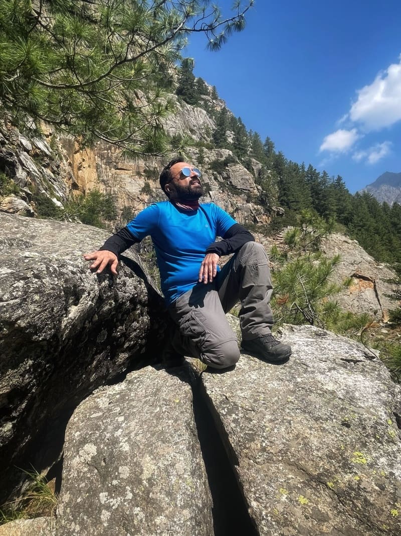 Trekkers sitting on a boulder